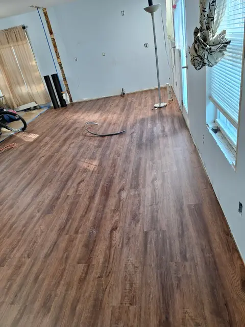 Luxury vinyl plank flooring installed in a bright living room, Kings Mountain Tile project in North Carolina