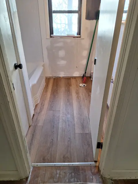 Vinyl plank flooring installed along a narrow hallway, Kings Mountain Tile project in North Carolina