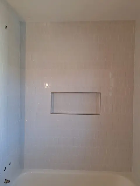 Tub surround with white tile and a recessed shelf niche, Kings Mountain Tile project in North Carolina