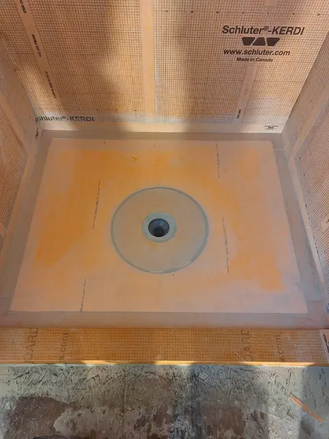 Shower drain on waterproof Schluter Kerdi membrane base, Kings Mountain Tile project in North Carolina