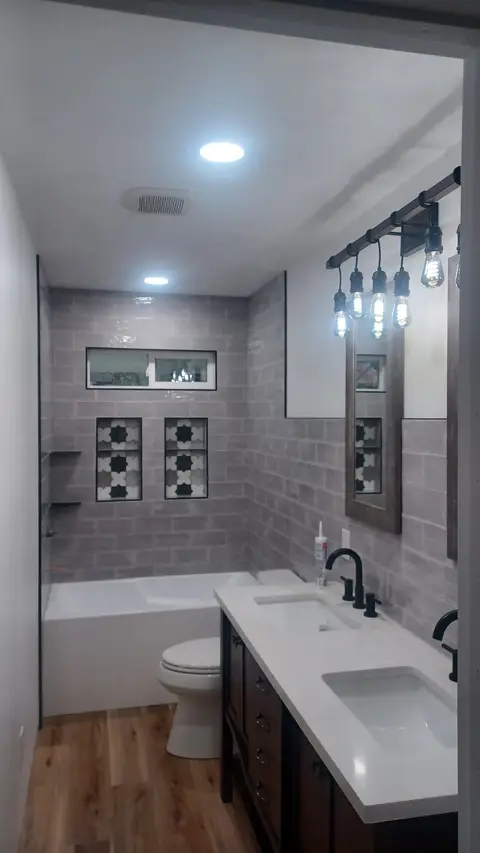 Bathroom remodel with gray tile walls, patterned accent tiles and double vanity, Kings Mountain Tile project in North Carolina