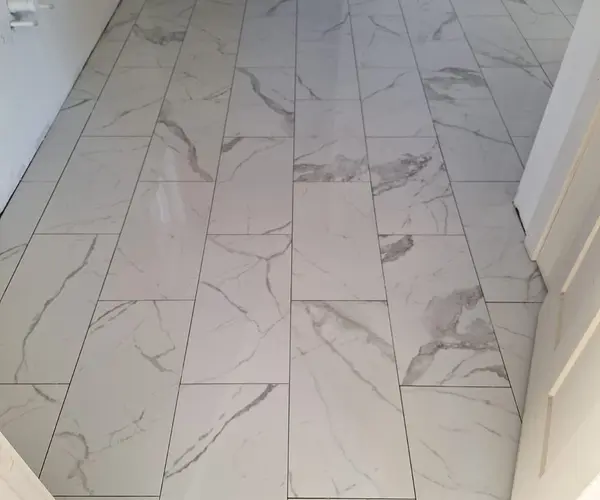 Large-format marble-look porcelain tile floor installed in North Carolina