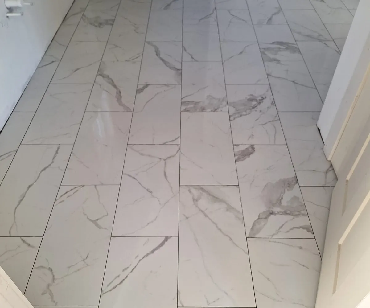 Large-format marble-look porcelain tile floor installed in North Carolina